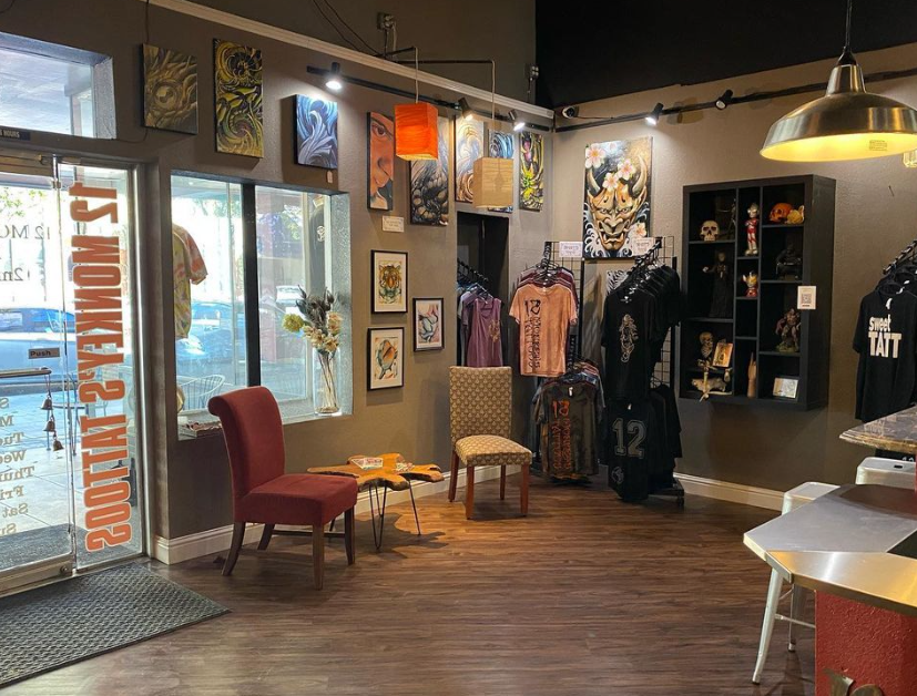An image taken from inside the studio, showing the door and the left side of the front of the shop, displaying some merch for sale.